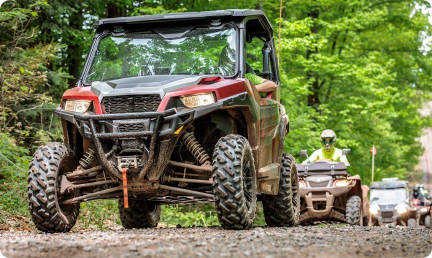 A group of ATVs riding along a trail. 