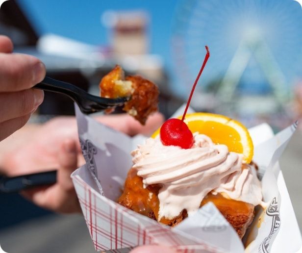 Two people enjoying a treat at the state fair. 