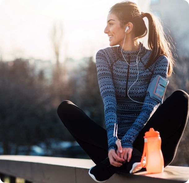 A woman takes a break from her run. 