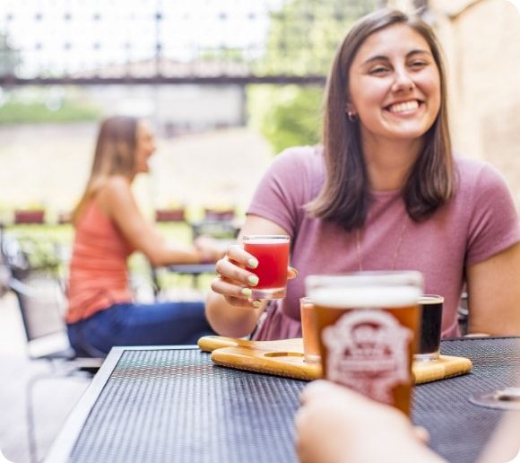 Two friends enjoying a flight of beers.  